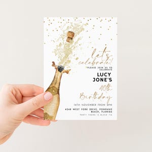 May include: A white invitation card with gold text and accents, held by a hand. The card reads "Let's celebrate!" and announces Lucy Jone's 40th birthday, with the date, time, and location. A champagne bottle is depicted with a cork popping.