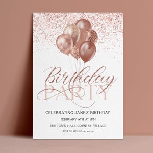 May include: A rectangular birthday party invitation card featuring a cluster of rose gold balloons and glitter accents at the top. The text reads Birthday PARTY, CELEBRATING JANE'S BIRTHDAY, FEBRUARY 14TH AT 7PM, THE TOWN HALL, COUNTRY VILLAGE, RSVP TO MEL AT 0123 456 789.