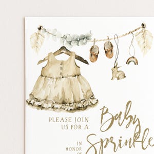 The image is a baby shower invitation featuring a dress, baby shoes, and a rabbit, along with the text "Please join us for a Baby Sprinkle" and "In honor of a".