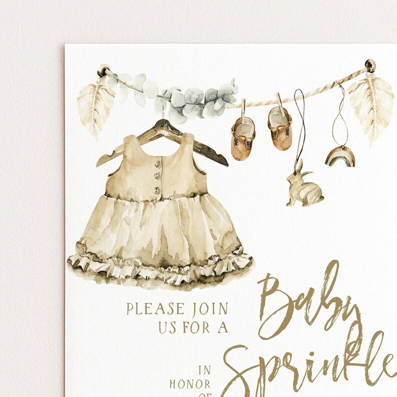 The image is a baby shower invitation featuring a dress, baby shoes, and a rabbit, along with the text "Please join us for a Baby Sprinkle" and "In honor of a".
