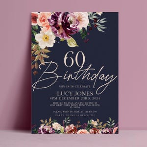 May include: A navy blue 60th birthday invitation card featuring watercolor floral arrangements in shades of deep purple, peach, and cream at the top and bottom. The text reads 60 Birthday, Lucy Jones, December 23rd, 2024, and event details.