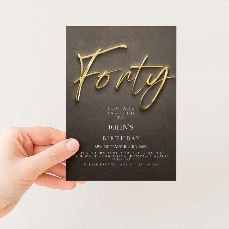 a person holding a birthday invitation card with the word "Fifty" written on it.
