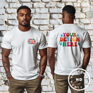 May include: White t-shirt mockup with the text "YOUR DESIGN HERE" in colorful, retro-style lettering with flower accents. The text is on the back of the shirt. The front of the shirt has the same text in a smaller size.
