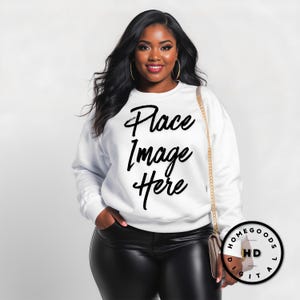 May include: White sweatshirt with the text "Place Image Here" in black script. The model is wearing black leather pants and gold hoop earrings. A gold chain strap purse is over the shoulder.
