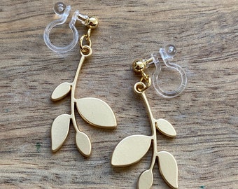 Dangling invisible clip on earrings with matte gold leaf pendants