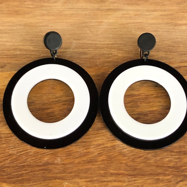 Oversized dangling black and white plastic hoop clip on earrings