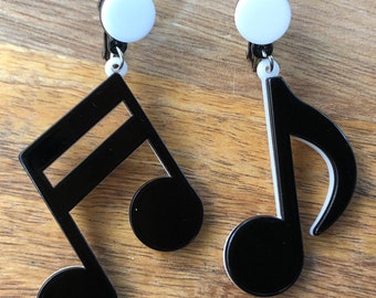 Dangling asymmetrical oversized black plastic music note clip on earrings (screwback )