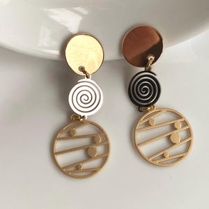Dangling clip on geometric mixed metal earrings