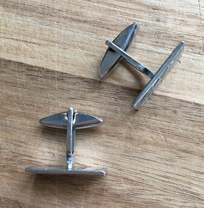 Vintage silver rectangular cuff links with a subtle pattern