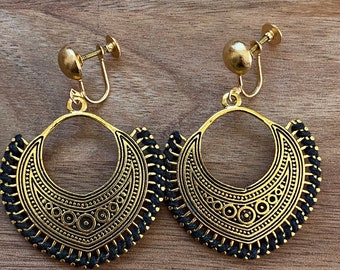 Dangling golden hoop clip on earrings with black accents