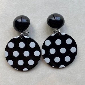 Dangling clip on black and white polka dot earrings
