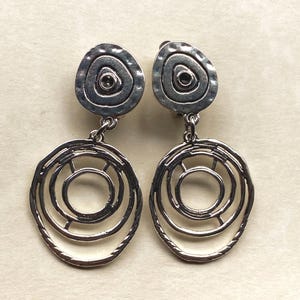 Silver dangling clip on abstract hoop earrings