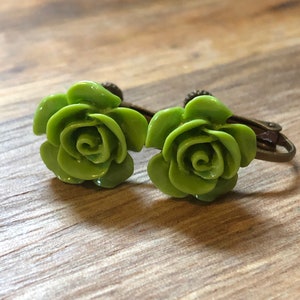 Medium sized Resin rose clip on earrings with hinged screwback closures.