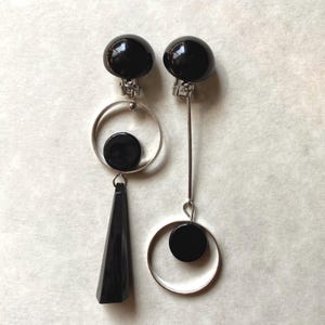 Asymmetrical clip on black geometric earrings
