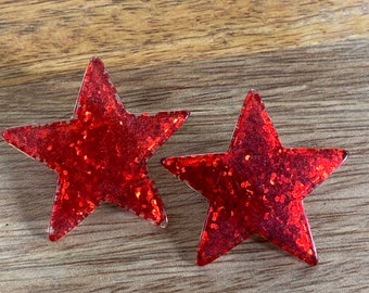 Big chunky plastic glitter clip on red star earrings