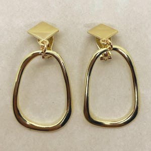 Dangling shiny gold hoop clip on earrings| simple geometric clip on hoops
