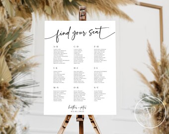 May include: A white wedding seating chart with the words "find your seat" in elegant script. The chart lists names alphabetically by last name, with the couple's names and date at the bottom. The sign is displayed on a wooden easel.