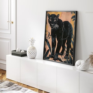 May include: A black panther silhouette print with a peach background and gold leaf accents. The print features a black panther walking through a jungle scene.