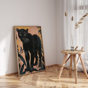 May include: A framed print of a black panther standing in a jungle setting. The panther is silhouetted against a peach-colored background with dark green foliage.