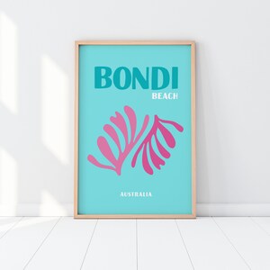 May include: A turquoise blue poster with the text "BONDI BEACH AUSTRALIA" in white. The poster features a pink stylized illustration of a plant.