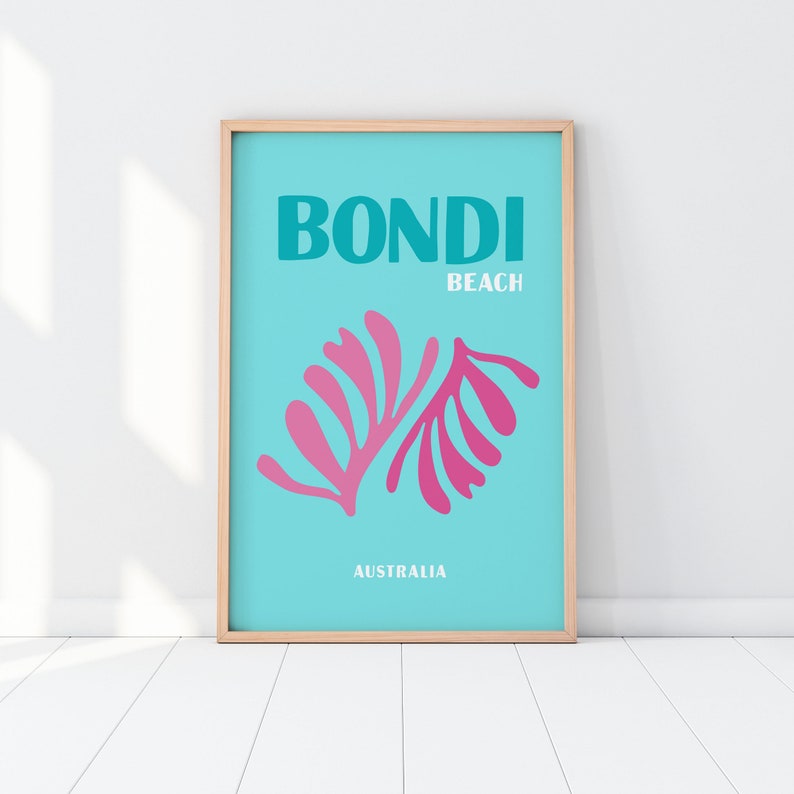 May include: A turquoise blue poster with the text "BONDI BEACH AUSTRALIA" in white. The poster features a pink stylized illustration of a plant.