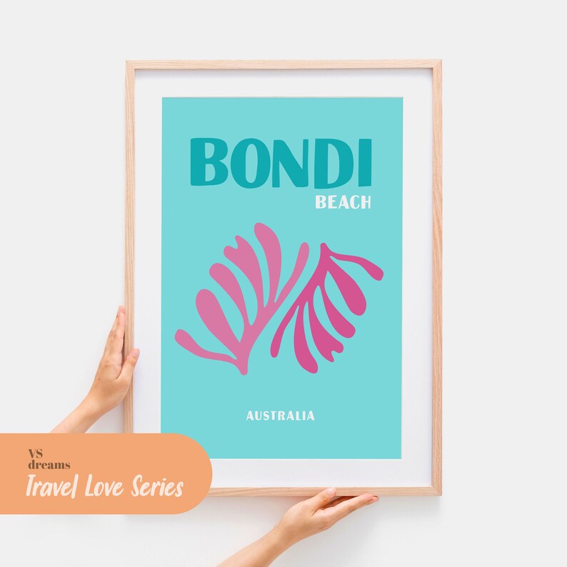 May include: A framed poster with a turquoise background and a pink stylized leaf design. The poster reads "Bondi Beach" and "Australia". The poster is part of the "vs dreams Travel Love Series".
