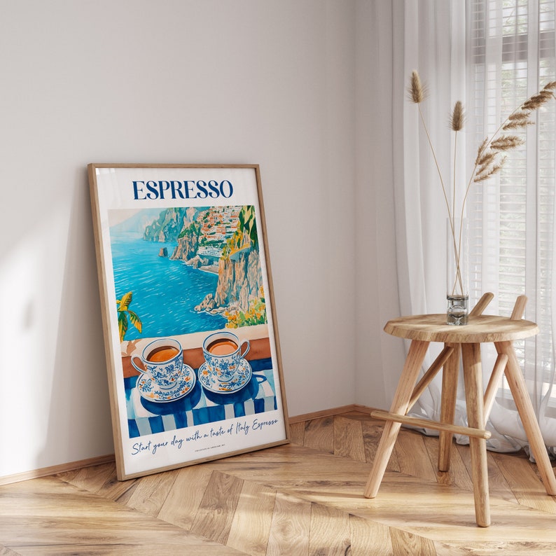 May include: A poster with a blue and white illustration of a coastal scene with two cups of coffee on a striped table. The poster has the text "ESPRESSO" in blue and white letters and the text "Start your day with a taste of Italy Espresso" in white letters.