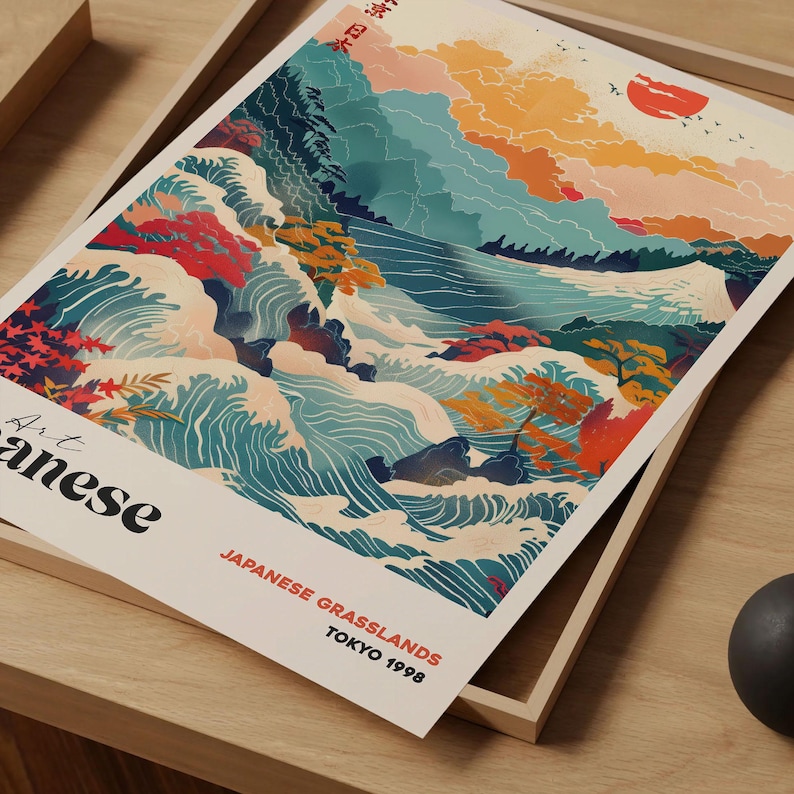 May include: A print featuring a Japanese landscape with stylized waves, mountains, and a setting sun. The artwork uses a palette of blues, oranges, and reds. Text at the bottom reads "Japanese Grasslands, Tokyo 1998."