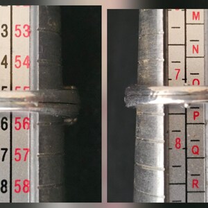 May include: A silver ring is being measured on a ring sizer. The ring is placed on the sizer, which has numbers and letters to determine the ring size. The ring appears to be a size 16 or 56.
