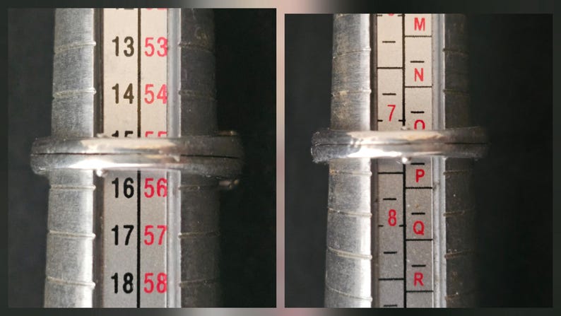 May include: A silver ring is being measured on a ring sizer. The ring is placed on the sizer, which has numbers and letters to determine the ring size. The ring appears to be a size 16 or 56.
