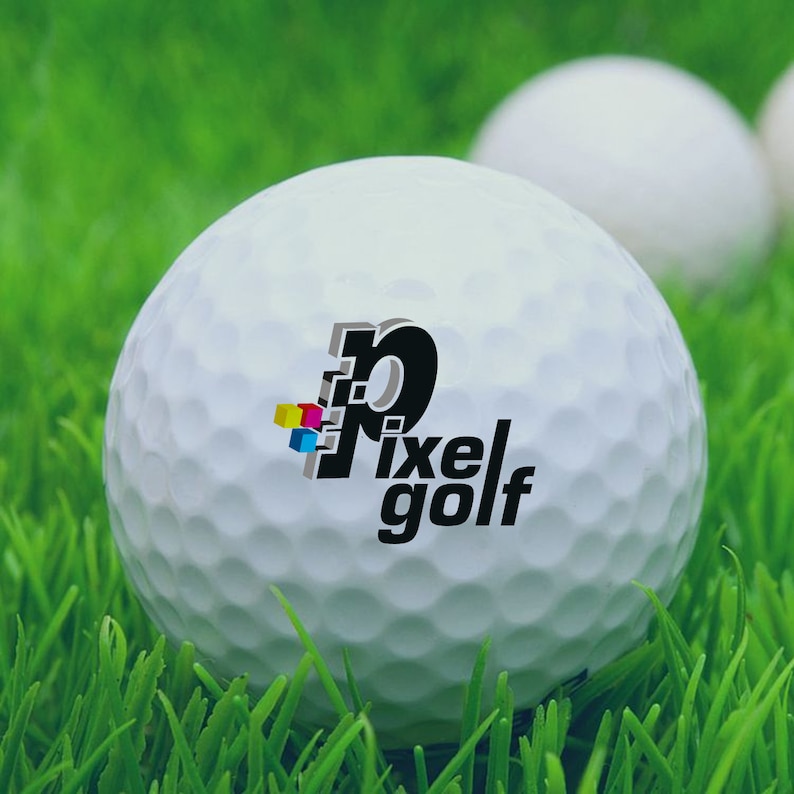 May include: A white golf ball with a black and white logo that says "Pixel Golf". The logo has a stylized "P" with a small, colorful design in the corner.