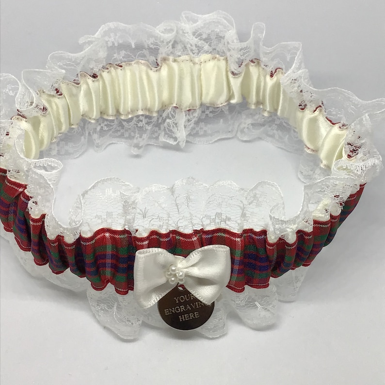 Wedding garter trimmed with lace and bow. Personalised Frazer tartan garter with engraved charm