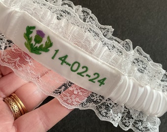 Embroidered personalised garter in white, bridal white or Ivory with a choice of embroidery thread colour, thistle logo plus name or date.