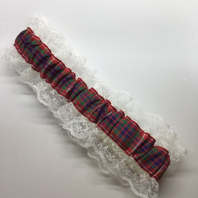 Wedding garter trimmed with lace and bow. Personalised Frazer tartan garter with engraved charm