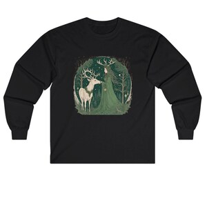 May include: Black long-sleeve shirt featuring a forest scene with a woman in a green dress and a white deer. The artwork is set within a circular frame, with trees and a starry sky in the background. The design is centered on the front of the shirt.