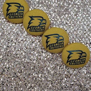 May include: Four yellow fabric buttons with a black eagle logo and the text "Georgia Southern" on each button.