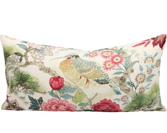 May include: A white pillow with a floral pattern featuring a bird, pink flowers, and green leaves.