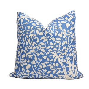 May include: A blue and white patterned throw pillow with a floral design. The pillow is made of a soft, comfortable fabric and is perfect for adding a touch of style to any room.