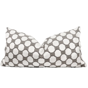 May include: White and brown patterned lumbar pillow with a geometric design.