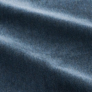 May include: Close-up of a soft, blue fabric with a textured surface. The fabric is folded and has a subtle sheen.