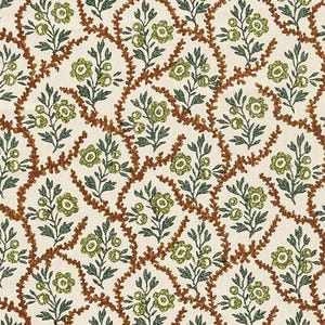 May include: Cream-colored fabric with a repeating pattern of green floral clusters and dark green leaves, connected by brown, vine-like lines. The design creates a lattice effect across the surface.