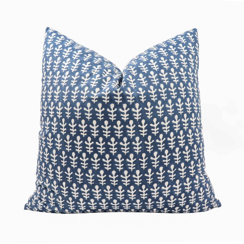 May include: A blue throw pillow with a white leaf pattern.