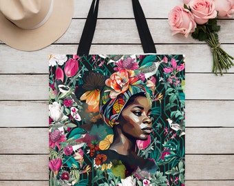 May include: A tote bag with a colorful floral design featuring a woman with a floral headwrap. The bag has black straps and the text "JOUK Brand" is visible in the bottom left corner.
