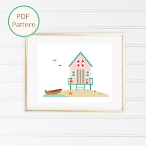May include: A cross-stitch pattern featuring a pink beach house with a green roof and a life preserver on the front. The house is on a small island with a boat and a starfish.