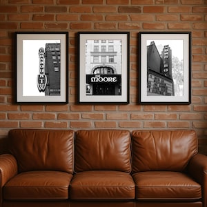 May include: Three framed black and white photographs of vintage theater marquees and architecture. The first features the Paramount Theater sign. The second displays the Moore Theater entrance. The third shows a marquee with show dates.