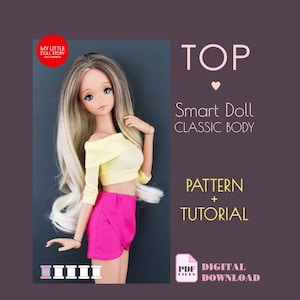 May include: A Smart Doll wearing a yellow off-the-shoulder top and pink shorts. The doll has long blonde and brown hair. Text on the image reads "TOP", "Smart Doll CLASSIC BODY", "PATTERN + TUTORIAL", and "PDF DIGITAL DOWNLOAD".