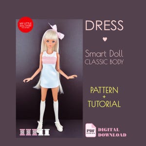 May include: A Smart Doll wearing a light blue and pink dress, white knee socks, and white shoes. The doll has long blonde hair and a pink bow. Text on the image reads "DRESS", "Smart Doll CLASSIC BODY", "PATTERN + TUTORIAL", and "DIGITAL DOWNLOAD".