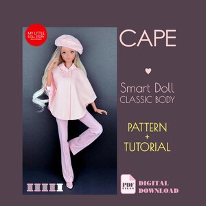 May include: A doll wearing a light pink cape, beret, and pants. The doll has long blonde hair and blue eyes. Text on the image reads "CAPE", "Smart Doll CLASSIC BODY", "PATTERN + TUTORIAL", and "DIGITAL DOWNLOAD".