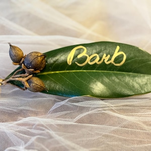 Magnolia Leaves w/ pink Flowers, blue Juniper berries or seed pods Place Cards. Romantic Wedding Decor. Dinner Cards. Handwritten lettering