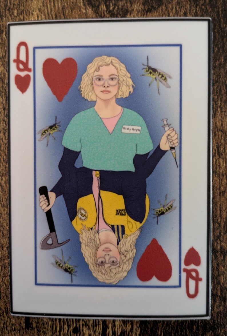 May include: A playing card featuring a queen of hearts. The queen is depicted as a woman with blonde hair wearing a green shirt, a yellow vest, and a blue jacket. She is holding a syringe in one hand and an axe in the other. There are several yellow and black wasps flying around her.